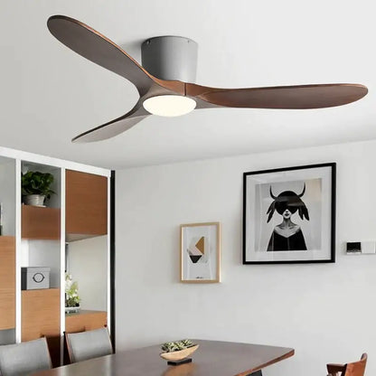 Modern ceiling fan with sleek curved dark wood blades and matte gray housing featuring remote control for low floor use