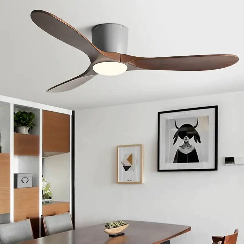 Modern ceiling fan with sleek curved dark wood blades and matte gray housing featuring remote control for low floor use