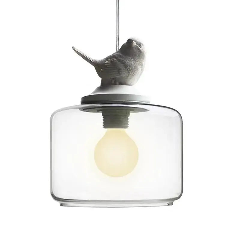 A sleek decorbites bird led glass chandelier with a matte gray bird figurine for modern dining room decor