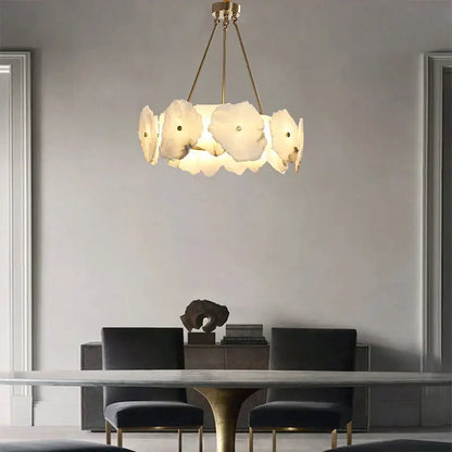 A modern decorbites brass marble ceiling chandelier with five off-white petal-shaped glass shades for dining rooms