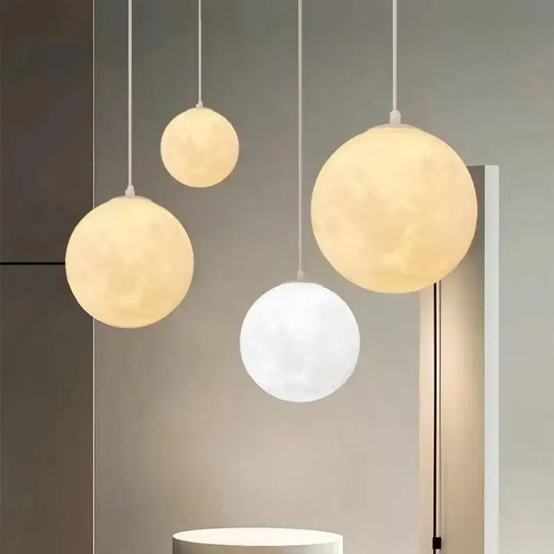 Three spherical cream moon led pendant chandelier lights with warm yellow and white translucent decorbites cream moon surfaces
