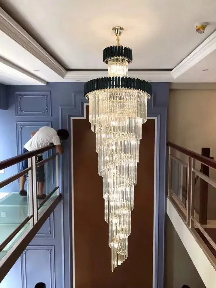 A modern decorbites crystal black clear led chandelier with cascading crystal rods and black metal frame for staircase