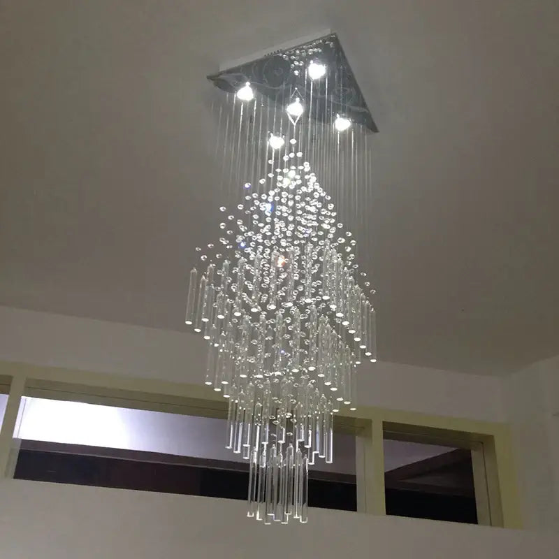 A modern decorbites crystal columnar chandelier with a triangular metal frame and clear glass strands for living room stair loft