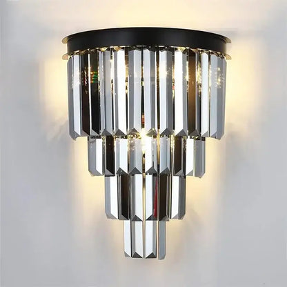 A modern decorbites crystal gold led chandelier with cascading faceted crystal prisms and a gold black circular base