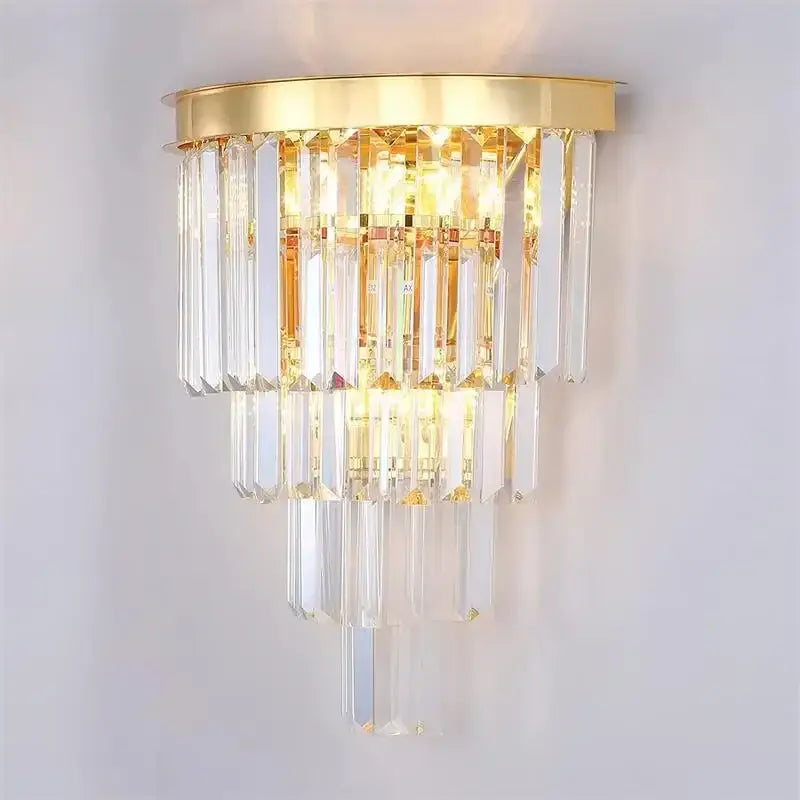 Modern decorbites crystal gold wall sconce featuring cascading clear crystal prisms in gold tone for elegant lighting