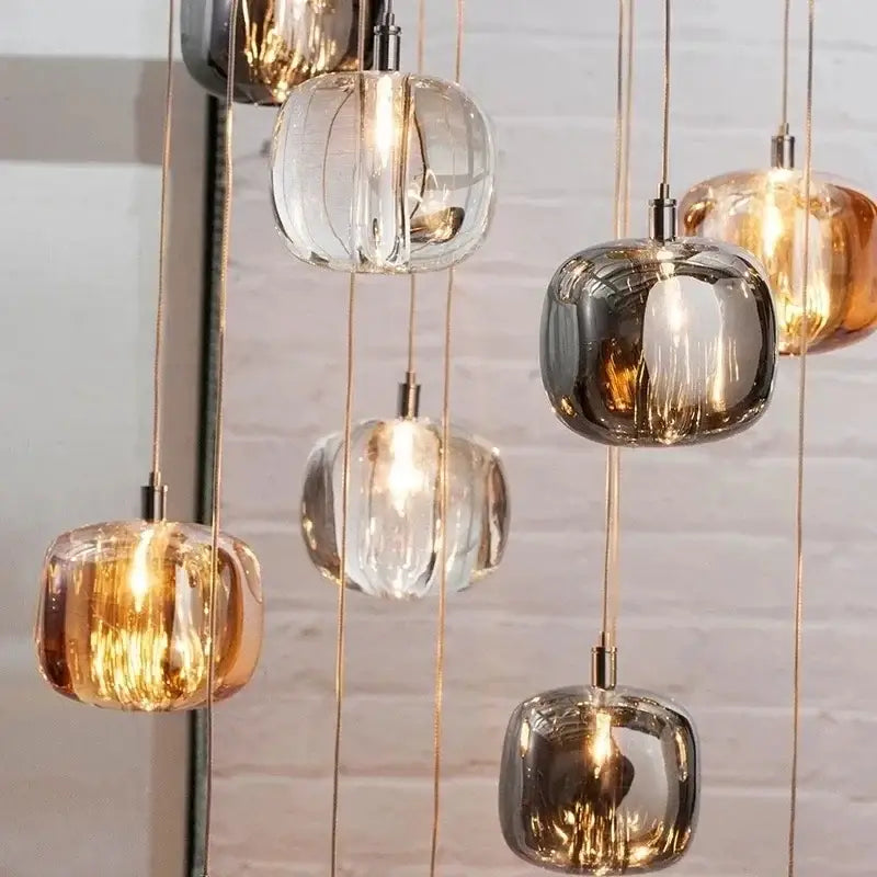A modern decorbites crystal led chandelier with spherical glass shades in clear amber and mirrored finishes