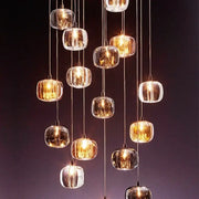 A modern decorbites crystal led chandelier with clear faceted glass orbs and metallic cords for living room lighting