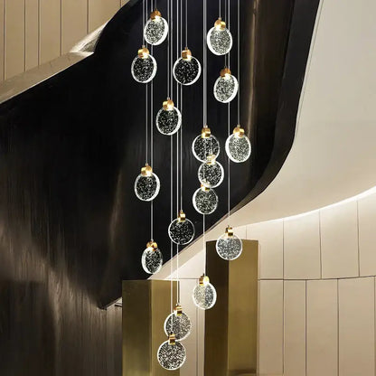 A modern decorbites crystal led chandelier with multiple glass orbs embedded with sparkling particles for living room