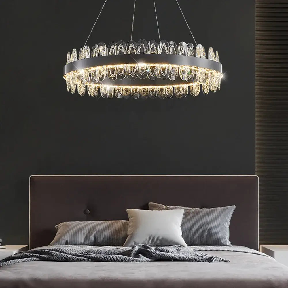 A modern decorbites crystal led chandelier with a black metal frame and cascading clear crystal droplets for living rooms