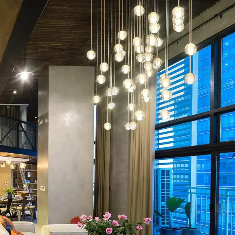 A modern decorbites crystal led chandelier with spherical glass orbs emitting warm glow for living room pendant light