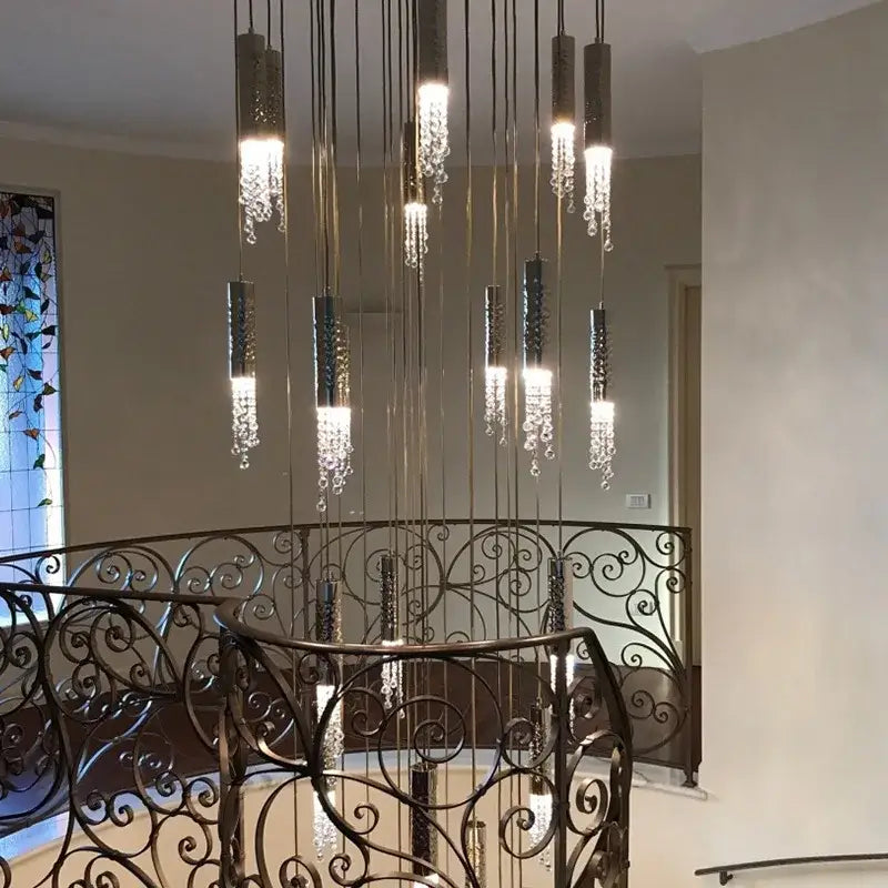 A modern decorbites crystal led large chandelier with cylindrical metallic fixtures and cascading crystal droplets for living rooms