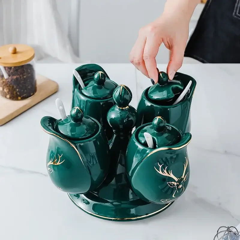 Modern deep green ceramic seasoning set with rotatable spice jars featuring gold deer motifs and built-in spoons