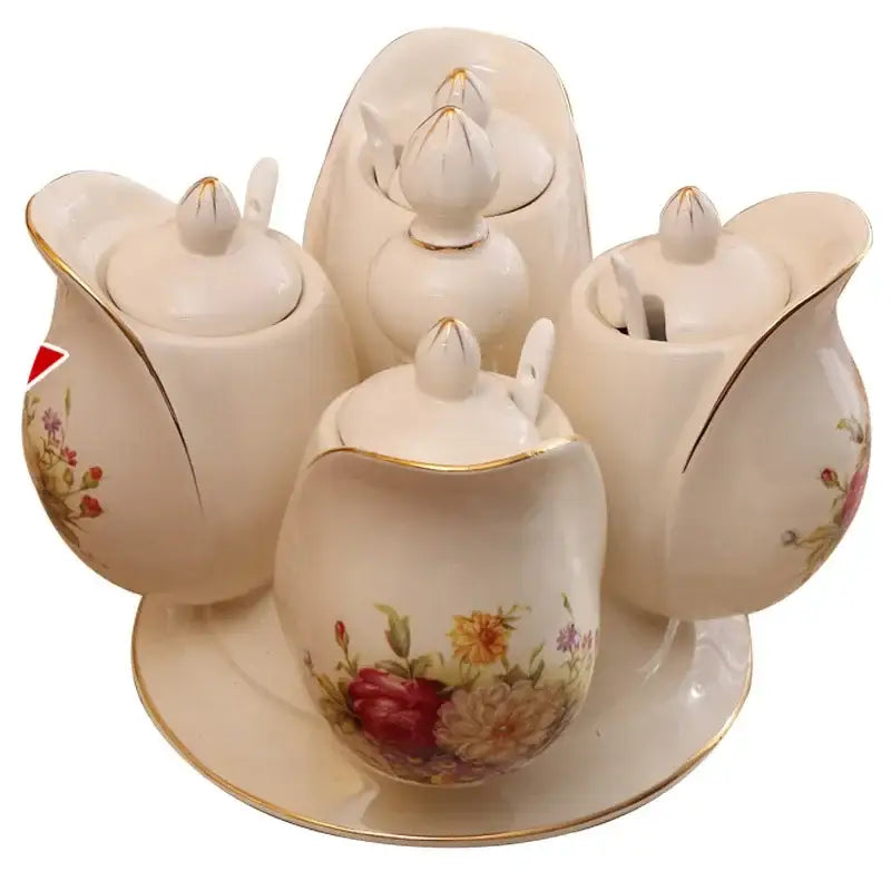 Cream-colored porcelain seasoning set with floral patterns and gold trim featuring rotatable spice jars for kitchen use
