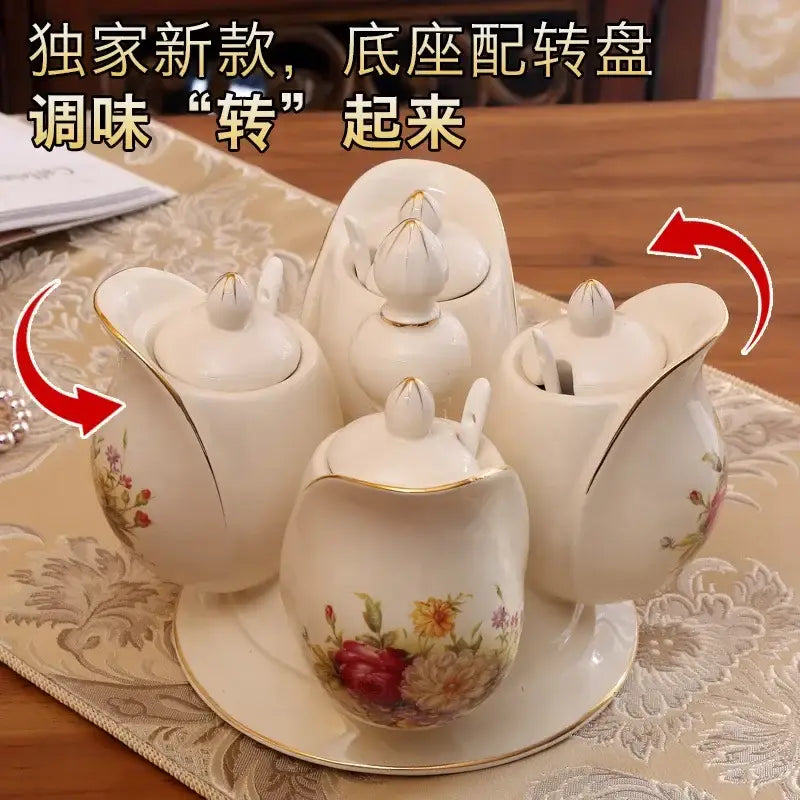 White porcelain seasoning set with floral patterns and gold trim featuring a rotatable spice jar on a central base