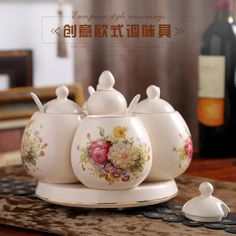 White ceramic seasoning set with floral patterns and gold trim featuring a rotatable spice jar for kitchen use