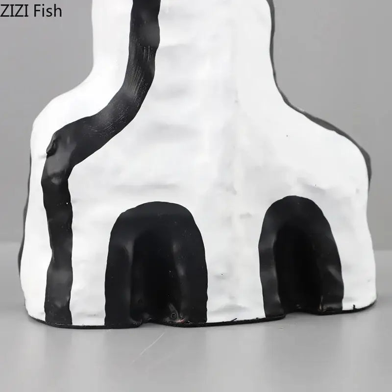 White ceramic decorbites abstract vase with black stripes and archways in modern design for bedroom decor