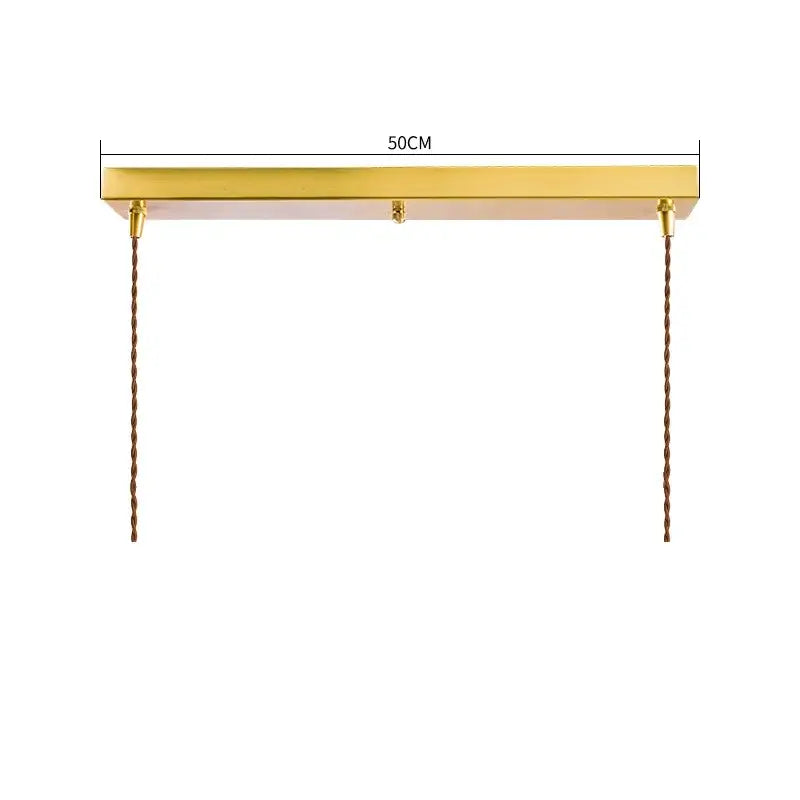 Gold-finished rectangular modern pendant lights with diamond amber glass and twisted brown cords for dining room use