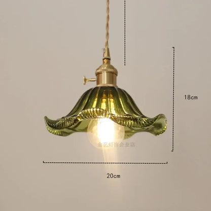 Vintage-style pendant light with golden brass fixture and olive-green ruffled diamond amber glass shade for dining room