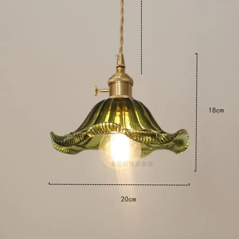 Vintage-style pendant light with golden brass fixture and olive-green ruffled diamond amber glass shade for dining room