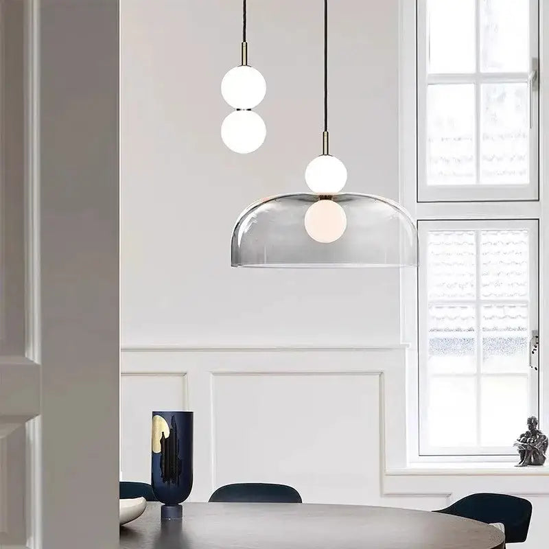 Modern pendant light featuring double balls glass with spherical white bulbs and transparent dome shade for kitchen use