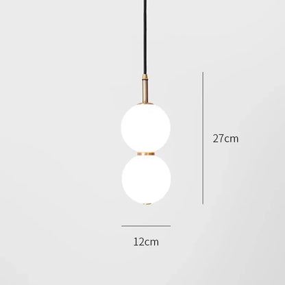 Modern pendant light with two frosted glass spheres and brass accents suspended by a black cord double balls glass chandelier