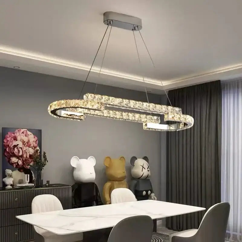 Modern silver-toned decorbites crystal ceiling chandelier with sleek double-loop design for living room or dining table
