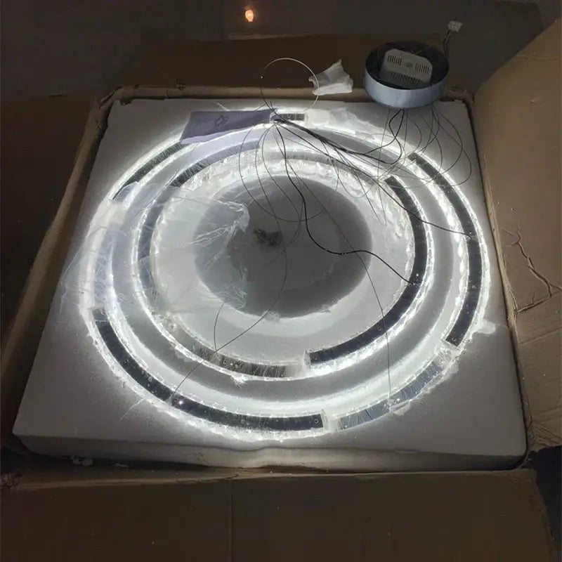 Modern double ring decorbites crystal ceiling chandelier with bright white LED rings and black accents in protective wrap
