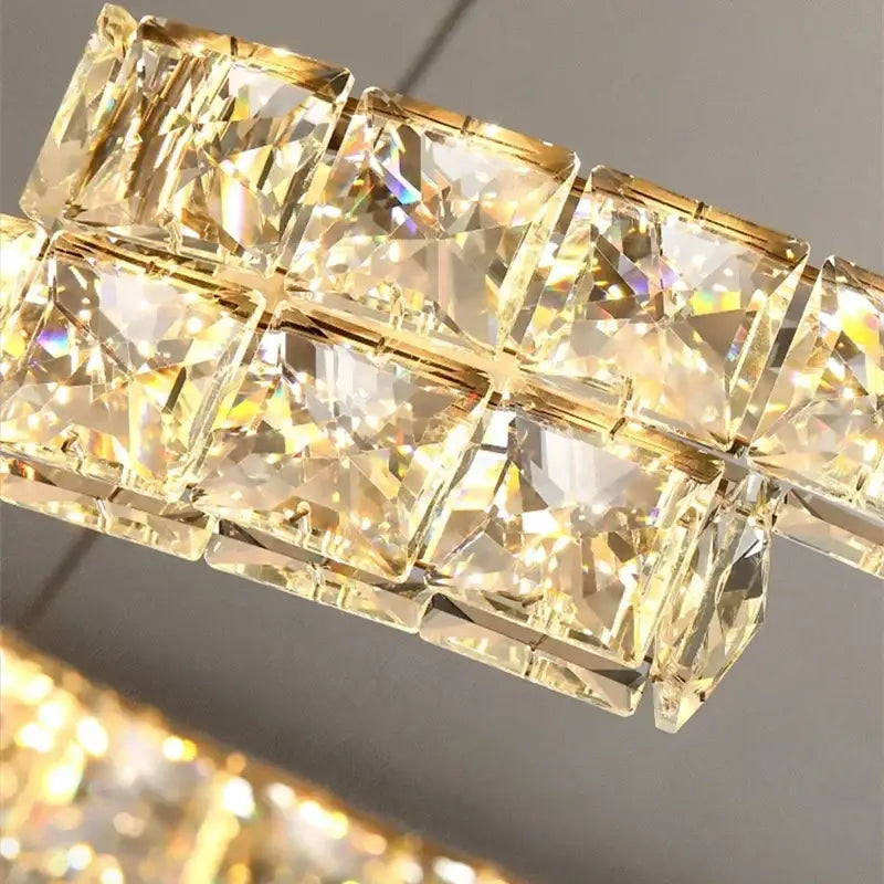 A modern decorbites crystal ceiling chandelier with golden faceted crystal squares in two rows for living room