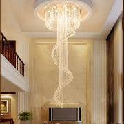 Modern double spiral staircase crystal ceiling chandelier with cascading crystals and warm light from circular mount