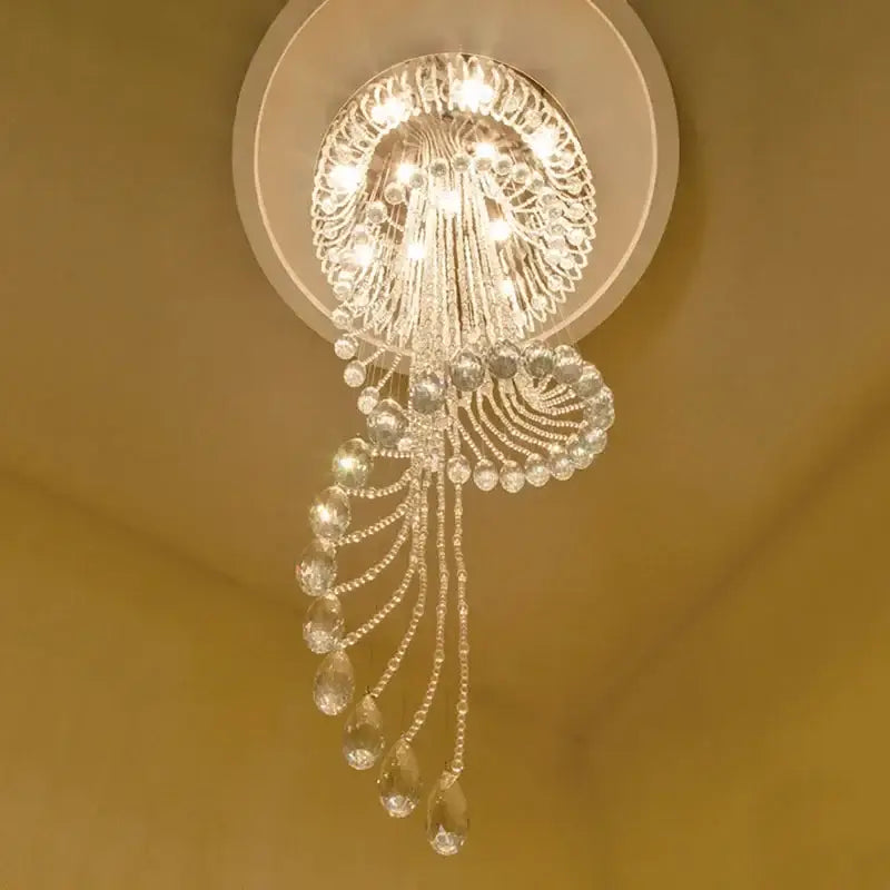 A sparkling crystal chandelier with teardrop crystals and ornate circular design for spiral staircase crystal ceiling