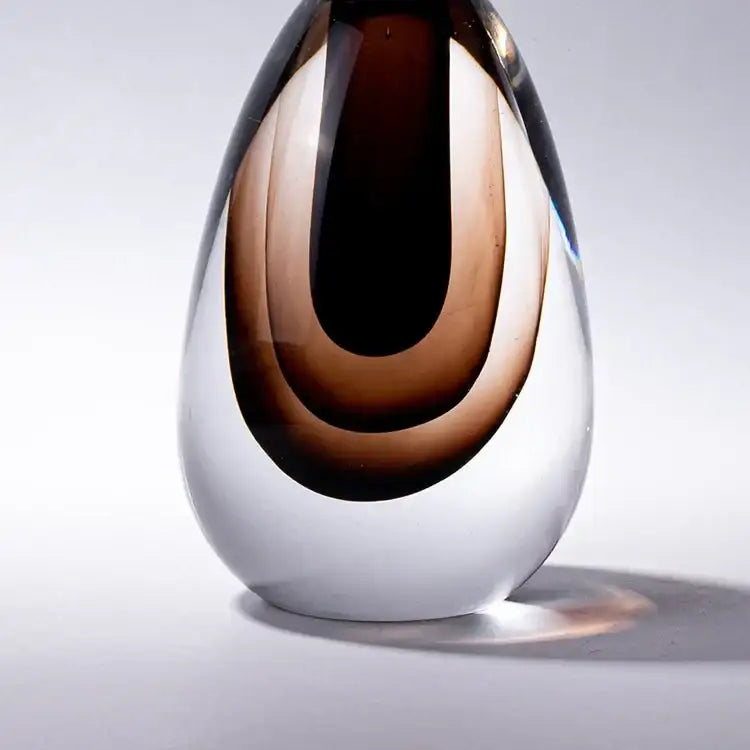 A sleek double stained glass vase with amber and deep brown layers encased in clear glass for modern decor