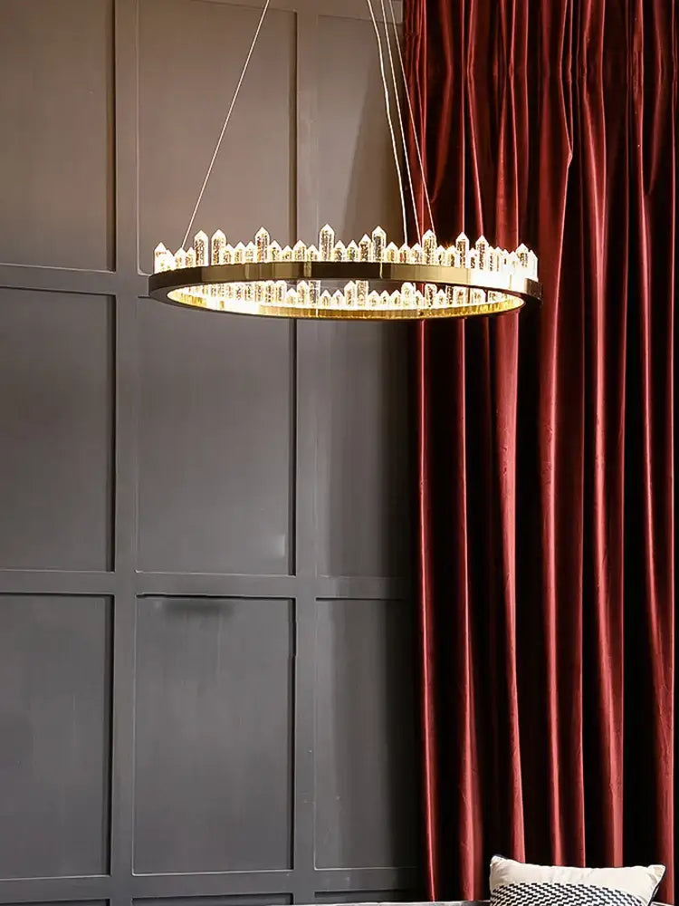 A modern double tier gold dimmalbe led crystal high ceiling chandelier with a circular metal frame and faceted crystals