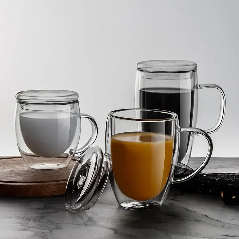 Modern clear double wall beer whiskey wine glass mugs with lids filled with milk and orange juice for kitchen use