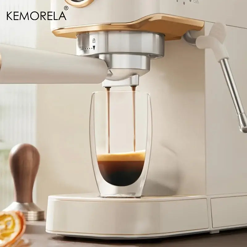 Cream-colored kemorela espresso machine brewing coffee into clear double wall glass coffee mugs in modern insulated set