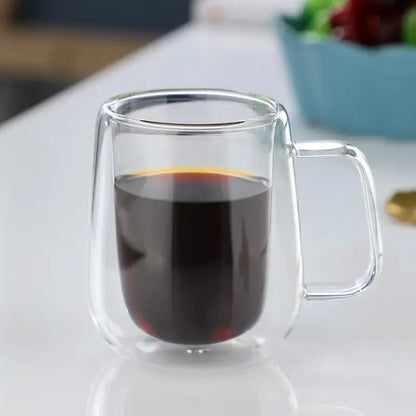 Modern double walled glass coffee mug filled with dark coffee featuring a clear decorbites glass coffee design