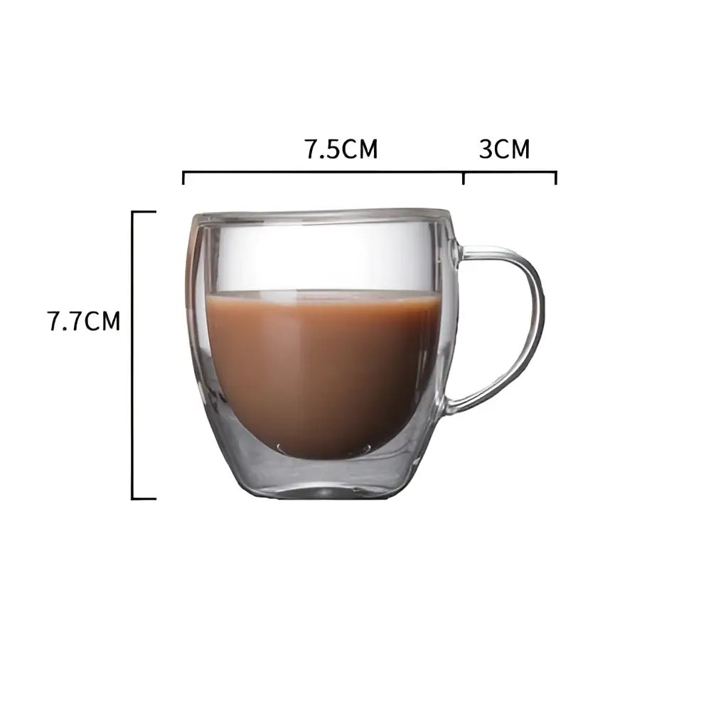 Modern double walled transparent glass cup with handle filled with brown liquid for kitchen and dining room use
