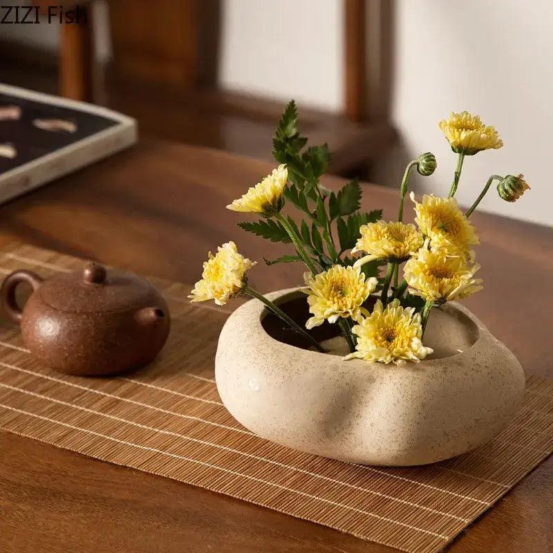 Beige lotus seedpod ceramic incense burner with smooth rounded shape and subtle speckled texture for living room decor