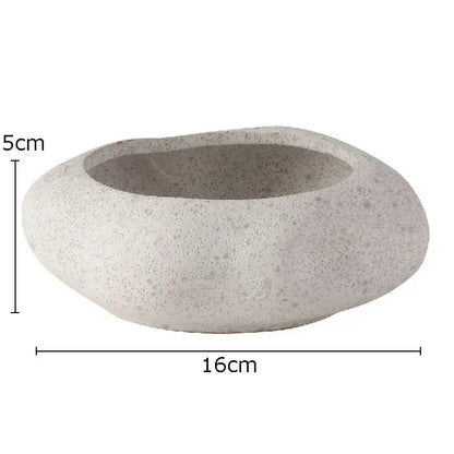 A smooth light gray lotus seedpod ceramic incense burner with speckled texture for modern living room decor