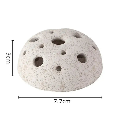 A light gray porous lotus seedpod ceramic incense burner with multiple circular holes for modern living room decor