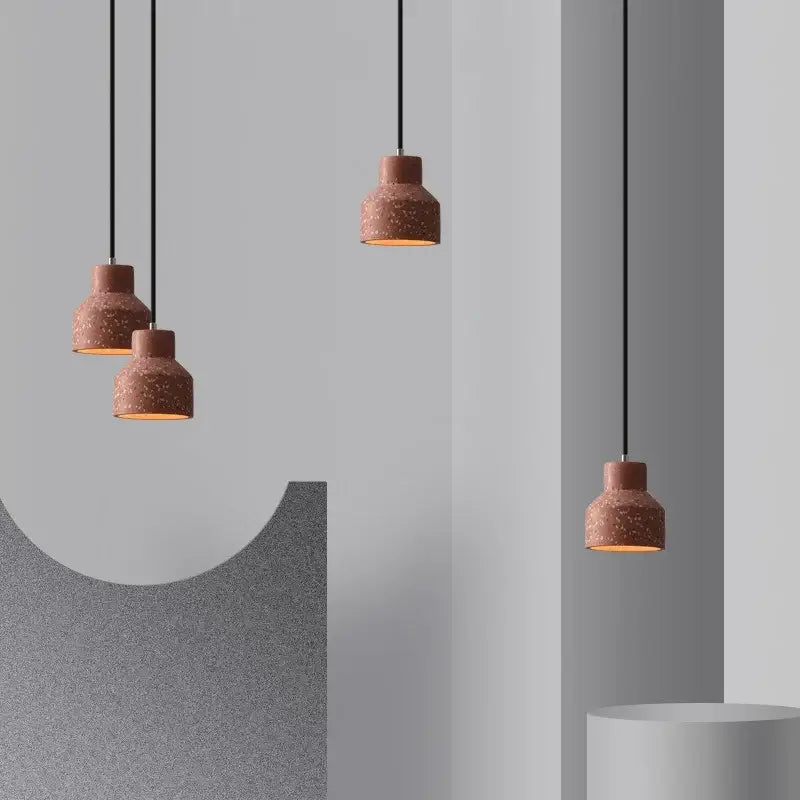 Modern earthy terrazzo stone led pendant light set featuring terracotta speckled textured finish and black cords for dining room decorbites terrazzo stone