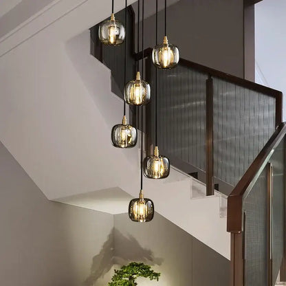 Five modern glass pendant lights with gold fixtures feature warm glow in decorbites elegant rotating staircase pendant light