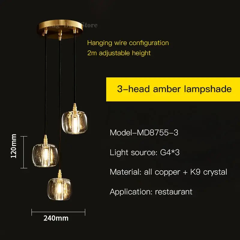 Gold-toned pendant light with three amber k9 crystal glass lampshades and black wires for elegant rotating staircase decorbites
