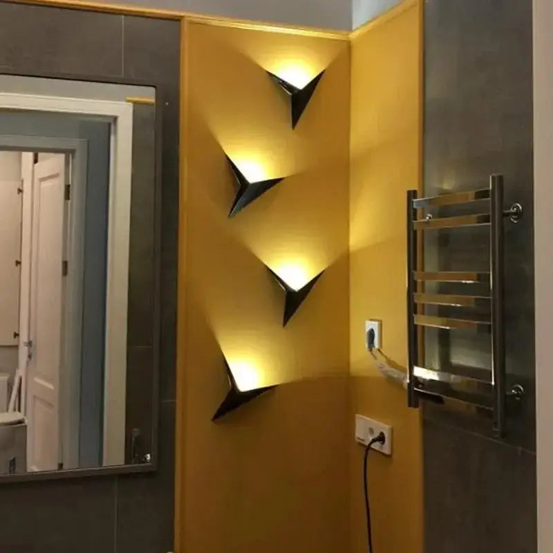 Modern elegant triangular led wall lamp in black with warm focused lighting for bedroom study decorbites elegant triangular wall lamp
