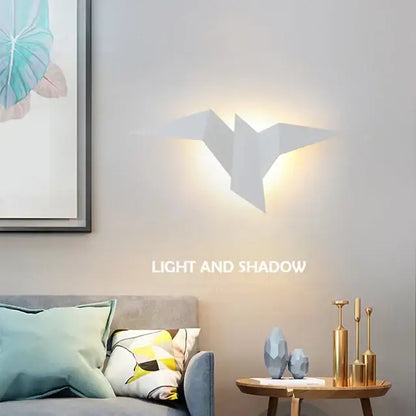 Modern elegant triangular led wall lamp white origami bird design casting warm glow ideal for bedroom study decorbites elegant triangular wall lamp
