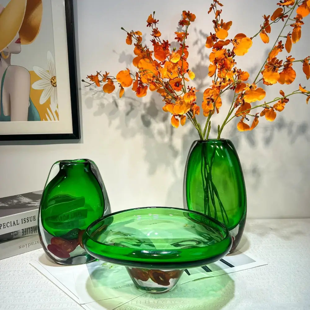 Modern emerald clear fruit tray vase in translucent green glass holding vibrant orange flowers for living room decorbites decor