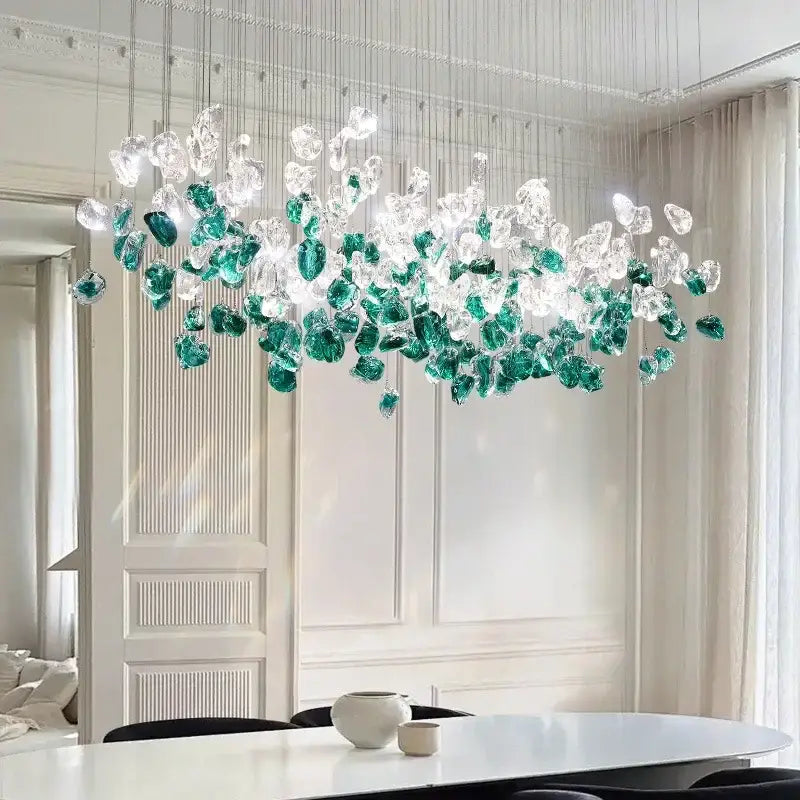 A modern emerald and clear glass stone chandelier with cascading glass stone pieces for dining room decorbites decor