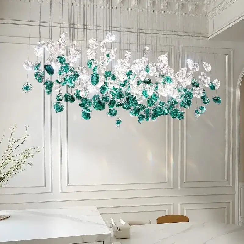 A modern emerald and clear glass stone chandelier with cascading glass pieces for dining room decorbites glass stone decor