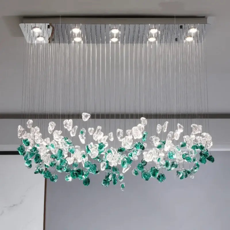 A modern rectangular glass stone chandelier with cascading clear and emerald green crystals for dining room decorbites decor