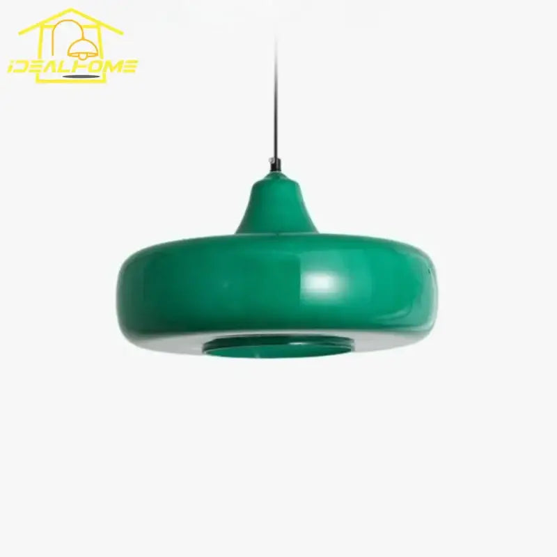 A modern emerald green glass pendant light with a glossy rounded disc shape and slender metallic suspension cord