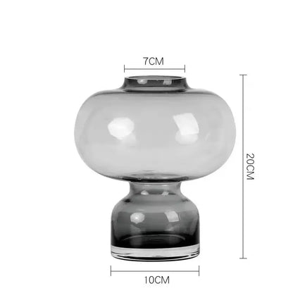A sleek translucent gray glass green gourd vase with a rounded bulbous body and matching base for living room decor